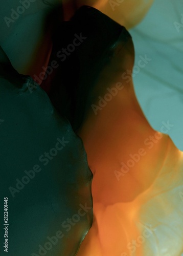 Abstract close-up of a flower petal. the petal is in various shades of orange, yellow, and green, creating a gradient effect.