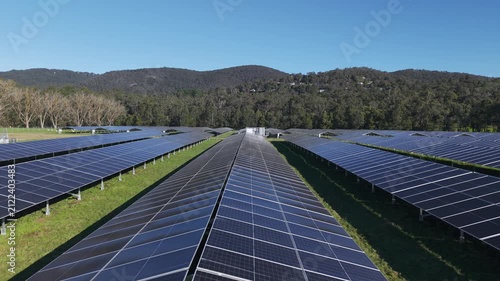 Aerial flight over a large solar farm generating renewable energy