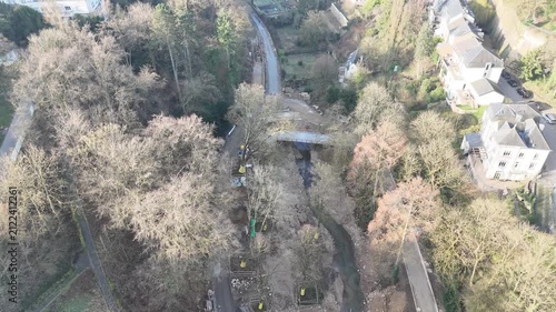 Drone reverse flyover from birds eye view panning up to reveal Pont Adolphe and Luxembourg City skyline