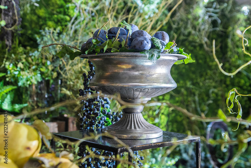resh ripe plums in a vintage metal bowl at a buffet