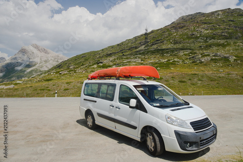 Картината върху платно Car van with kayak on top roof against mountain nature