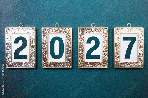2027 Happy New Year. 2027 in golden frame on green background. Festive concept 2027 New Year. New Year resolutions, celebrate, greeting card