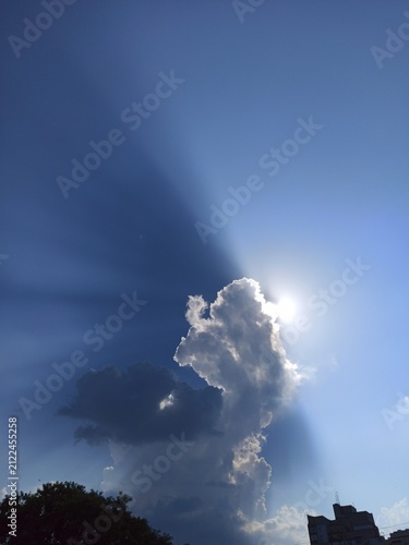 Quadro su tela Dramatic sun rays behind towering storm clouds over Mykolaiv, Ukraine