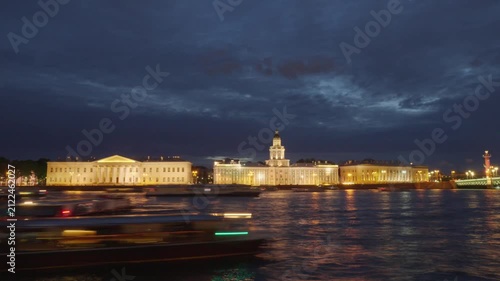 Night 4K timelapse of river boat traffic on the Neva in Saint Petersburg, with illuminated Academy of Sciences and Kunstkamera in the background.