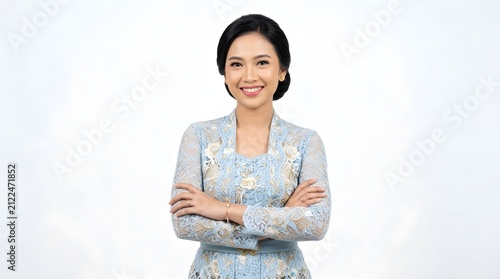 Portrait of confident Asian woman wearing traditional light blue kebaya dress