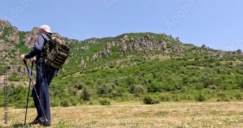 Couple walking against the backdrop of beautiful mountains and blue sky.