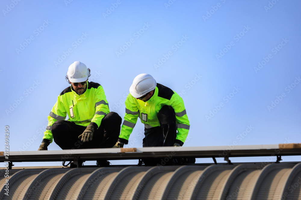 Fototapeta premium solar panel photovoltaic solarenergy electricity renewable.Technicians inspect rooftop solar panels during installation and maintenance, ensuring reliable renewable energy performance and efficient.