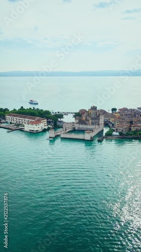 Aerial view of Sirmione Castle with surrounding lake and old town. Medieval architecture on Lake Garda