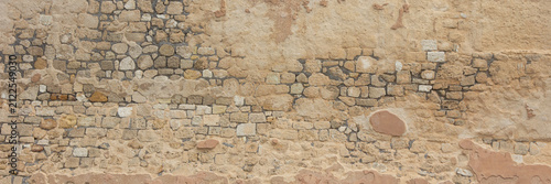 Old weathered stone wall texture with rustic masonry background