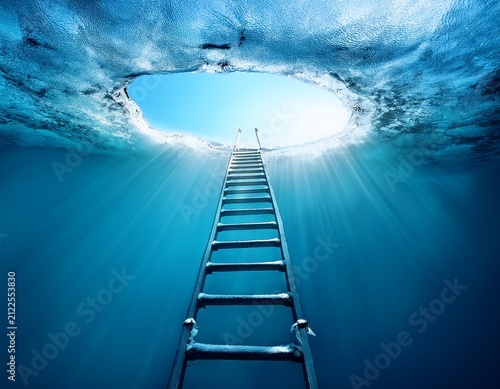 ladder leading upwards through ice hole into deep blue water with sunlight beams
