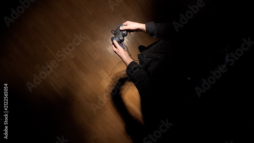 Фотография Gamer hands are holding a wired video game controller