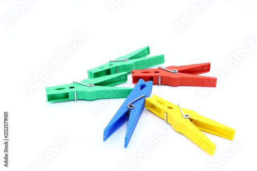 Multicolored plastic clothespins. White background.