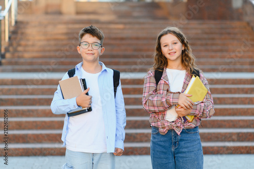 Schoolchildren ready for lessons studying university campus