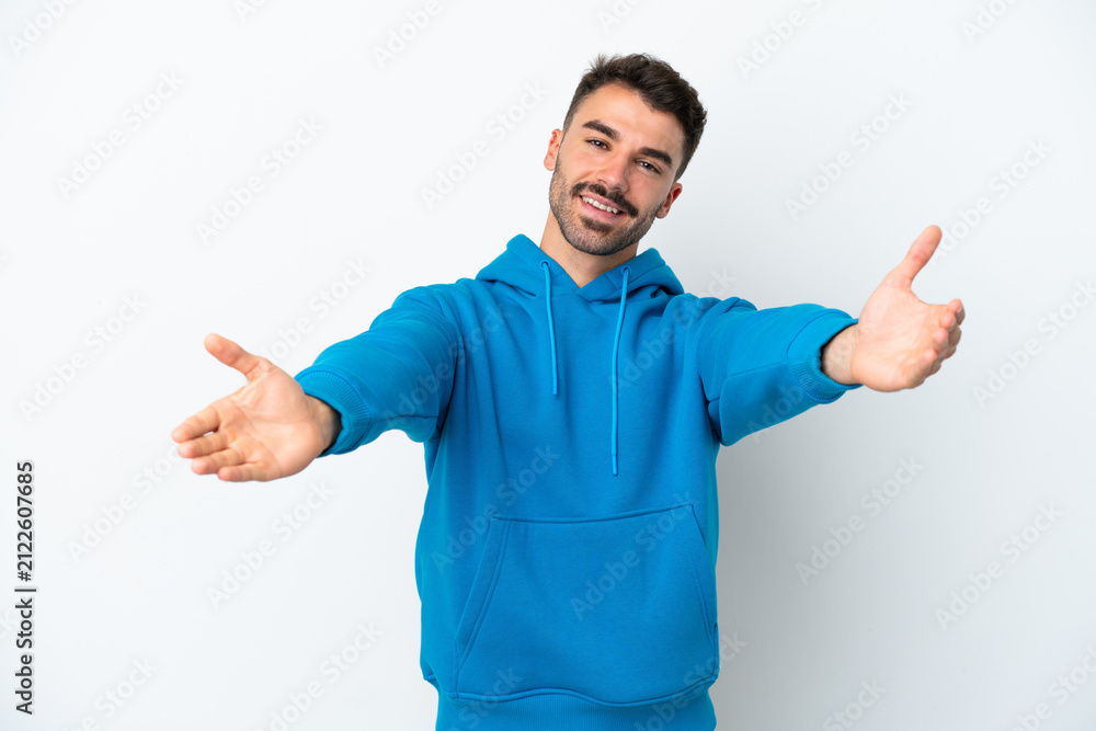 Fototapeta premium Young caucasian man isolated on white background presenting and inviting to come with hand