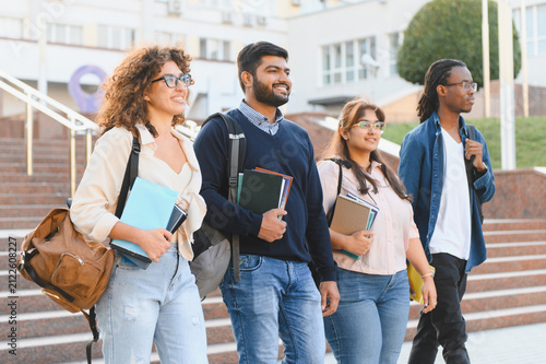 Diverse students walking on university campus together
