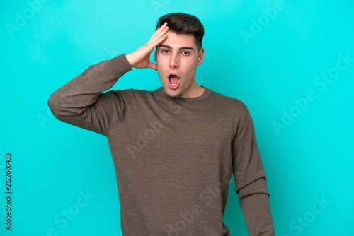 Canvas Print Young caucasian man isolated on blue background has realized something and inten