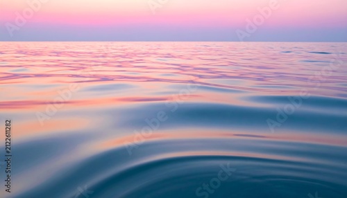 Calm ocean water ripples reflecting pastel pink and blue sunset light for a serene World Maritime Day background