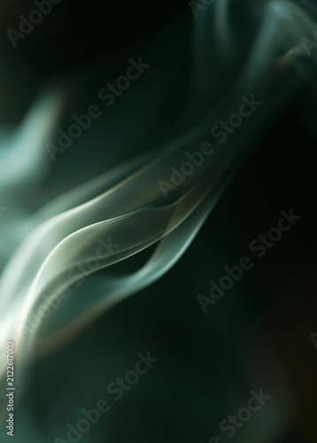 Close-up of a wavy line of smoke. the smoke appears to be in motion, with the ends of the line curving upwards towards the right side of the image.