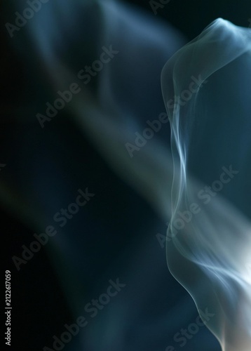 Close-up of a white smoke-like substance on a black background. the smoke appears to be wavy and curving upwards, creating a sense of movement and depth.