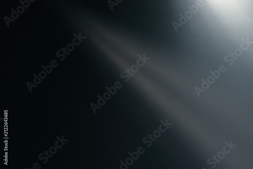 Abstract dark background with a soft diagonal beam of light, minimalist gradient texture