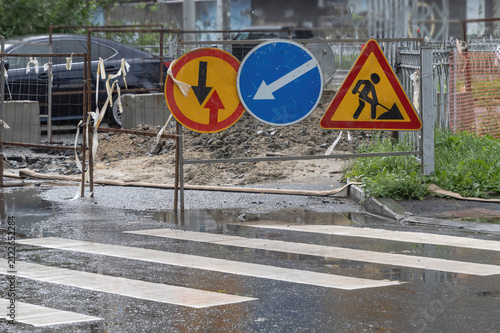 Road signs at the repair site on a summer day