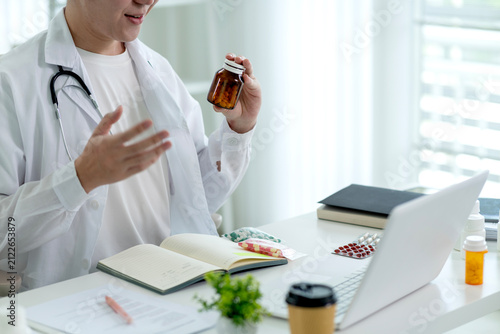Male Doctor Explaining Medication Instructions During Online Telemedicine Consultation at Modern Clinic Office
