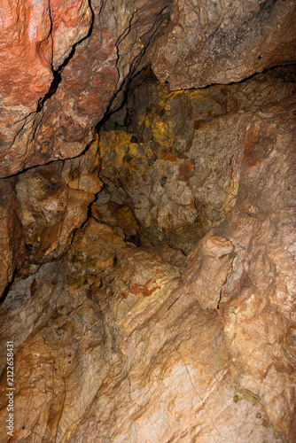 Bild auf Leinwand Close-up texture of a rough natural limestone wall inside a dark cave