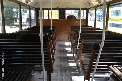 Slated wooden seats in vintage bus.
