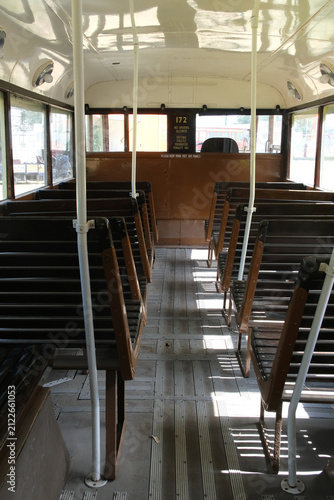 Slated wooden seats in vintage bus.
