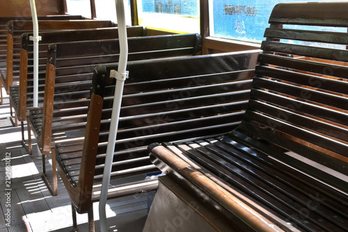 Slated wooden seats in vintage bus.