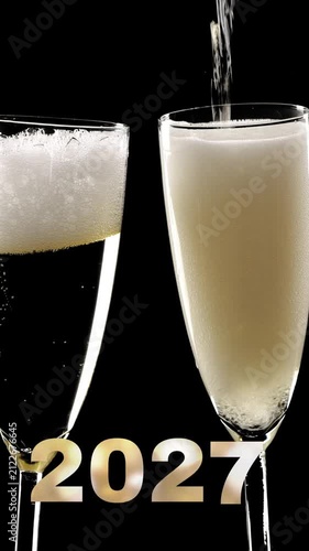 change from 2026 to 2027, two clinking champagne glasses with exploding fireworks isolated on black, cheers to new year 2027