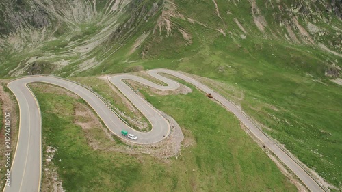 Aerial tracking shot of a car driving on the winding Transalpina mountain road in Romania