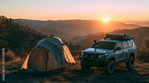 Scenic sunset camping scene with tent and four-wheel-drive vehicle in mountainous landscape