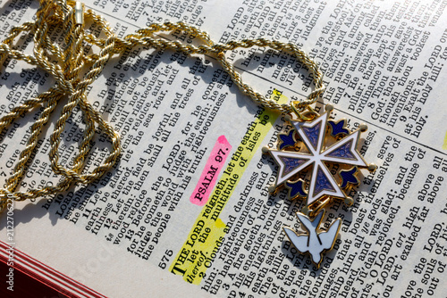 фотографія A Protestant Huguenot cross on a Bible opened to Psalm 97.