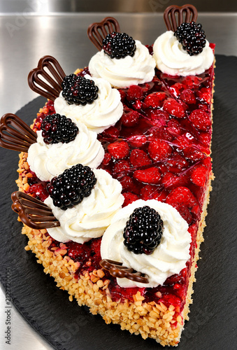 Berry cake with whipped cream, blackberries, raspberries and chocolate
