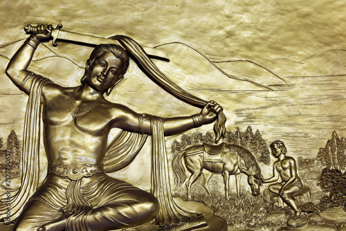 Quoc Tu Pagoda, Vietnam. This gilded sculpture depicts Siddhartha Gautama cutting his hair with a sword, symbolizing his renunciation of the material world. Ho Chi Minh City, Vietnam.