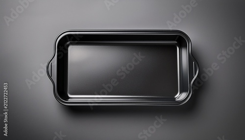 sleek black rectangular baking tray on smooth surface overhead view of a vacant foam food