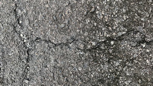 фотографія Cracked asphalt pavement surface showing aggregate exposure and signs of wear fr