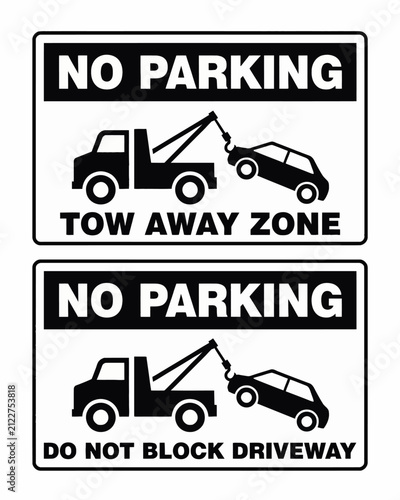 Two no parking tow away zone signs with car being towed illustrations