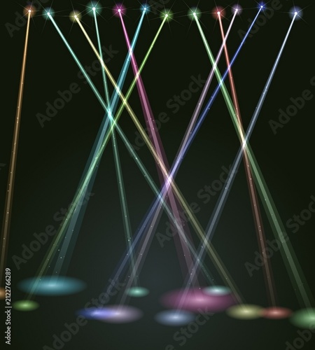 Colorful stage spotlight beams shining down on dark background floor