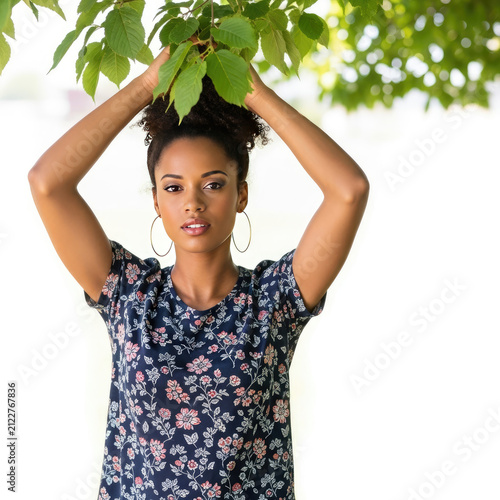  Portrait of beautiful young woman with curly hair posing in sunny park