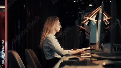 Programmer Working On Computer In Dark Office Late Night. Software Developer. Overtime