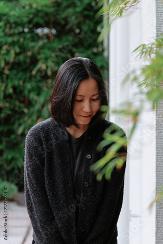 Portrait of a Demurely Smiling Asian Woman.