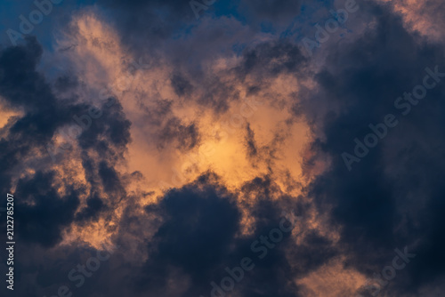 Cloudscape with dark and dramatic clouds at sunset in summer