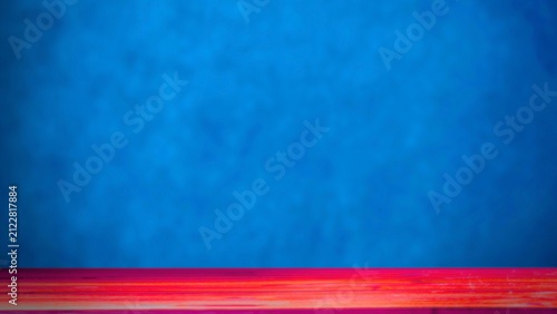 Abstract red wooden floor surface against vibrant blue textured wall background