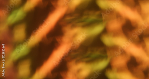 Blur optical gleam. Abstract orange flare. Vibrant pink yellow color lens shiny rainbow on glisten flash radiant bokeh light luminous background.