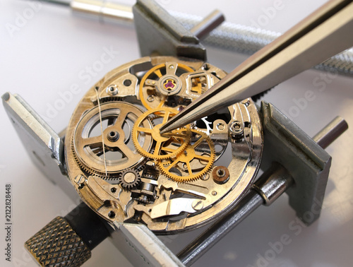   Macro photography concept of internal mechanism and vintage gears of a mechanical watch under repair