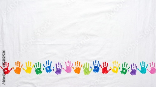 Row of rainbow handprints forms a playful border on clean white. Bright paint imprints create cheerful copy space for school projects, classroom materials, banners, and invitations.