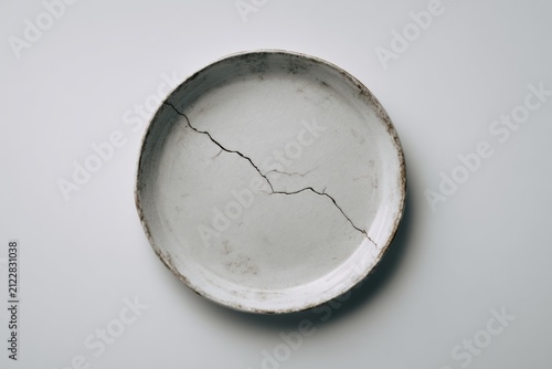 Cracked Ceramic Plate Minimal Imperfection Concept Isolated on White Background
