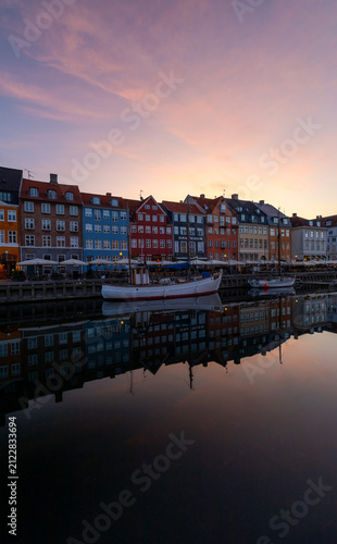 Colorful Nyhavn houses glowing softly in early summer morning twilight